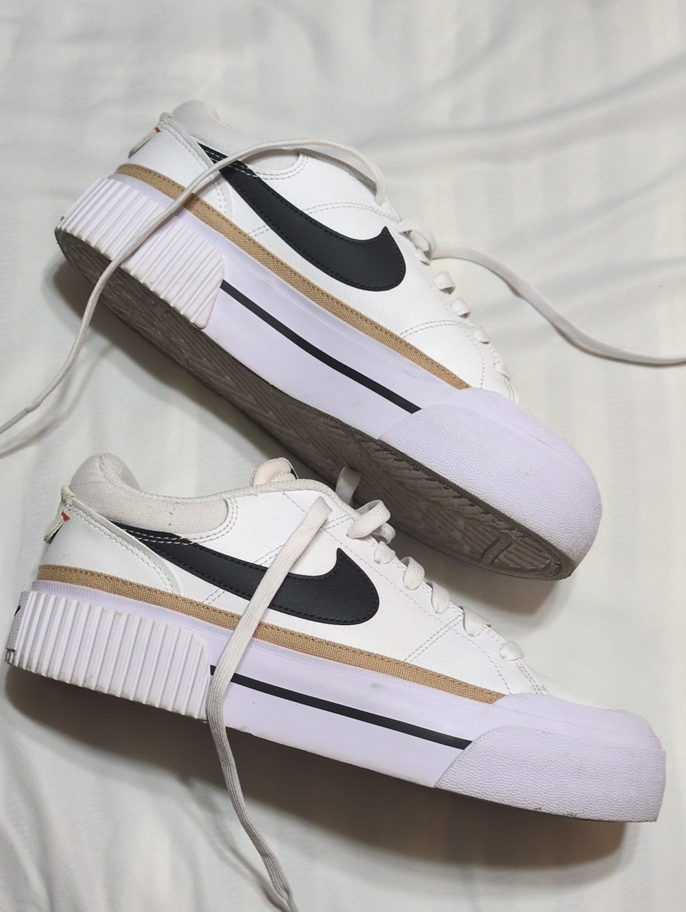 Nike Women's White Sneakers with Black Swoosh and Tan Trim